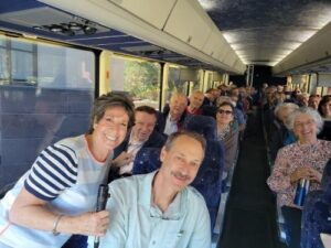 Skirball director Abby Schwartz and mustachioed photographer J. Miles Wolf (in foreground) lead a bus tour of Jewish Cincinnati in November (Courtesy)