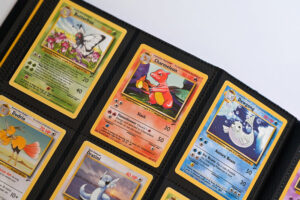 Several Pokemon cards in an album, with the fire Pokemon Charmeleon centered in the frame