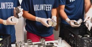 volunteers stacking cans at food shelf.