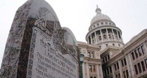 A stone etching of the ten commandments in front of a State Capitol Building